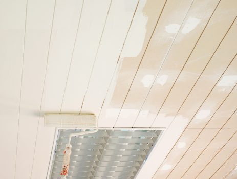 Ceiling painting in construction site using roller brush